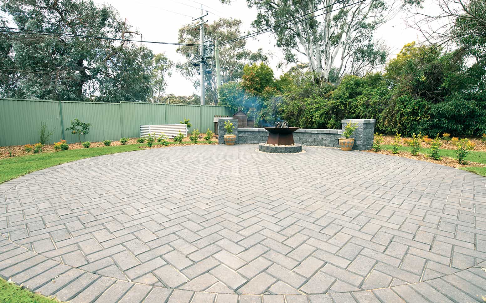 a brick patio with a fire pit